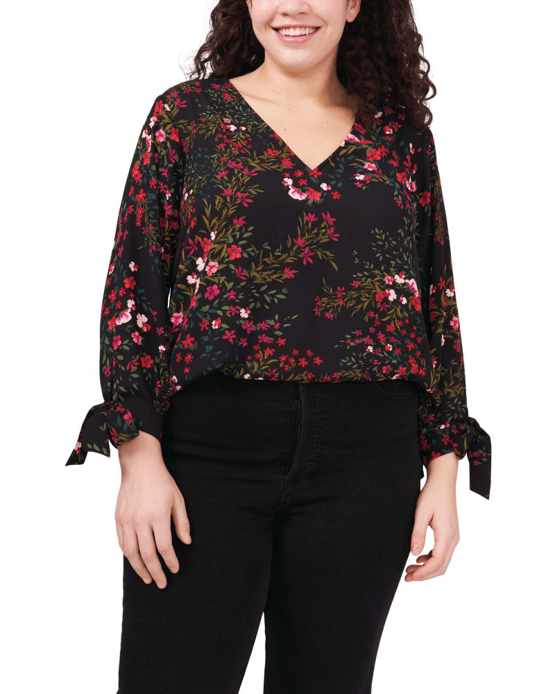 Front of a model wearing a size 1X Festive Garden Tie Sleeve Blouse in RICH BLACK by CeCe. | dia_product_style_image_id:263837
